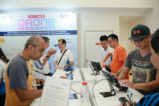 Drone enthusiasts and members of the public learning about the proposed enhancements to the unmanned aircraft regulatory framework at the Civil Aviation Authority of Singapore (CAAS) booth