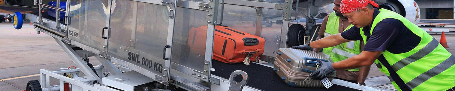 Photo of workers loading baggage onto plane